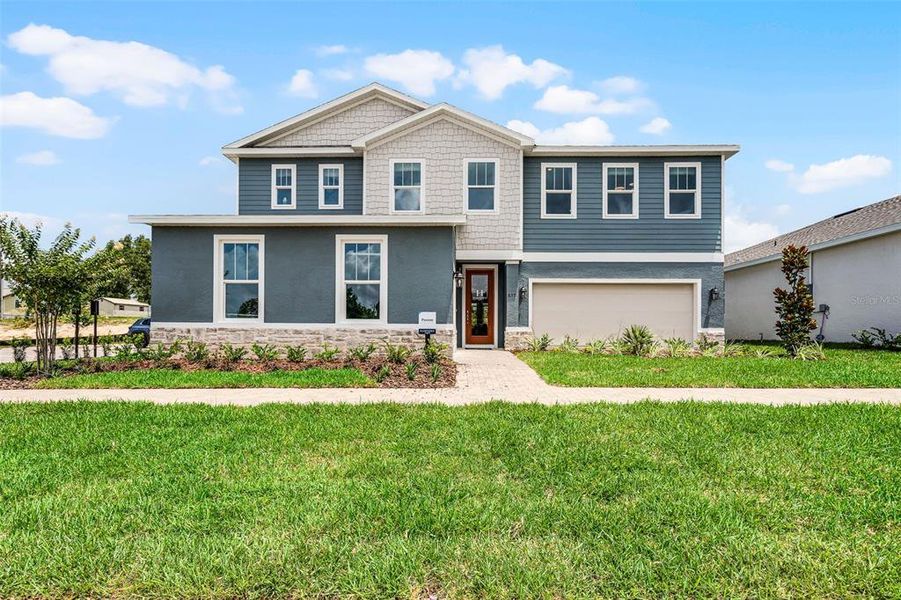 Front exterior of a new home in Eden Crest, Apopka, FL, highlighting curb appeal (Image 1).