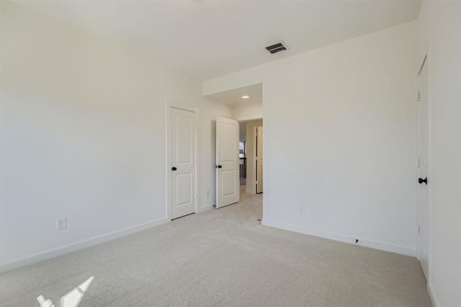 Unfurnished room with light carpet and recessed lighting Unfurnished room with light carpet and recessed lighting