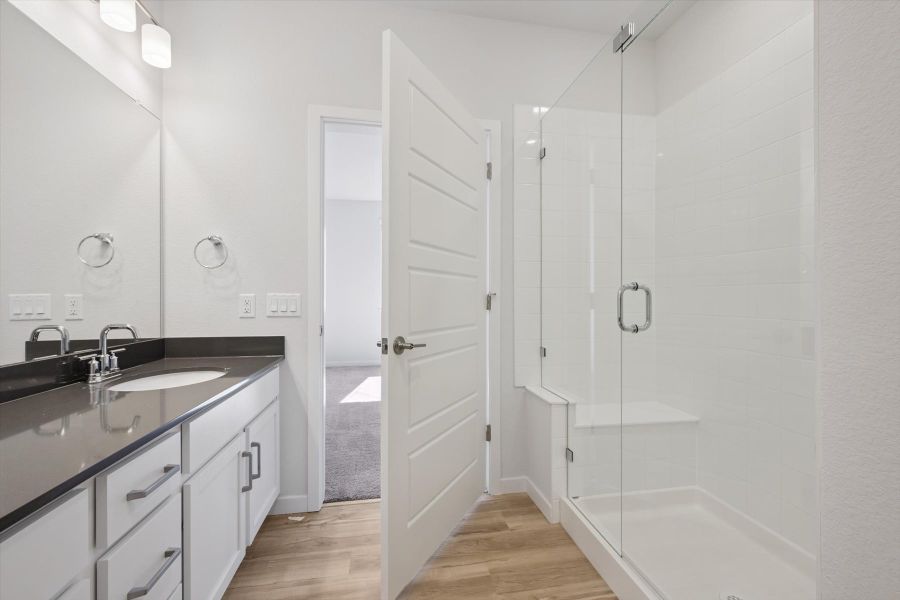 A bathroom with a sink and a shower. A bathroom with a sink and a shower.