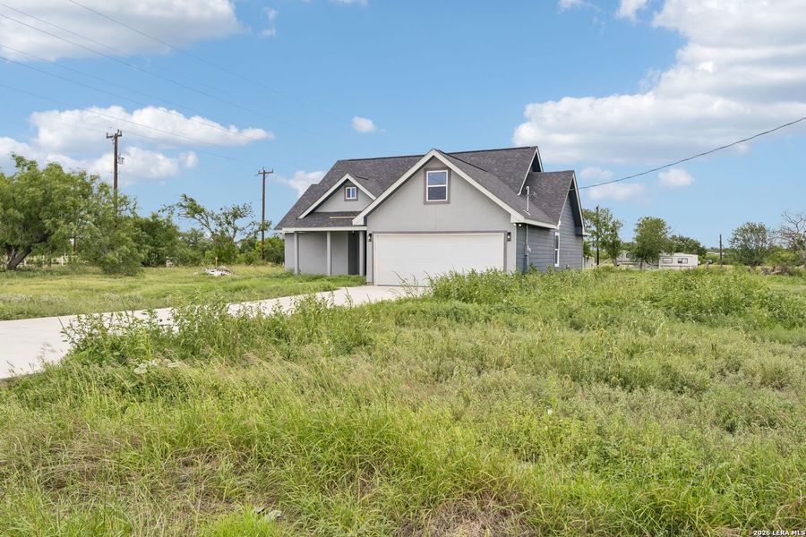 Front exterior of a new home in , Natalia, TX, highlighting curb appeal (Image 21).