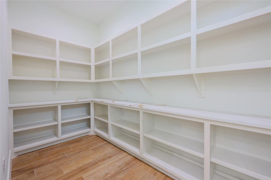 Oversized custom luxury pantry with quartz countertops as well. Oversized custom luxury pantry with quartz countertops as well.