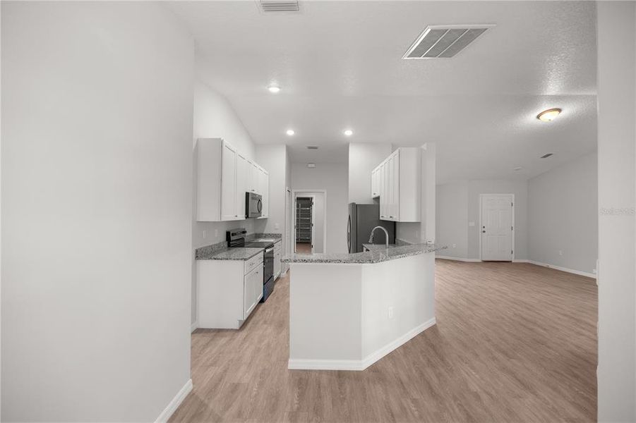 View of kitchen and living room from Breakfast Nook