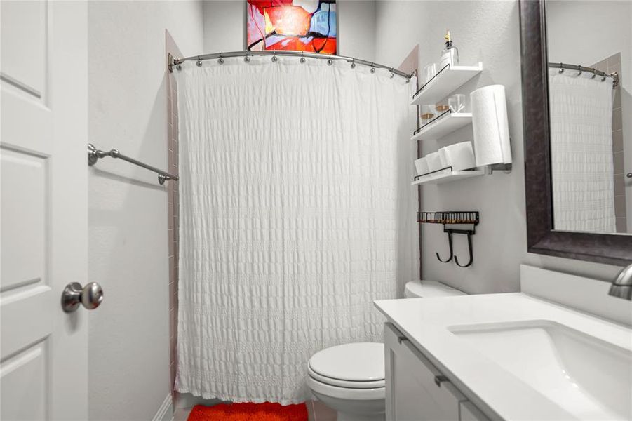 Full bath featuring vanity and curtained shower Full bath featuring vanity and curtained shower