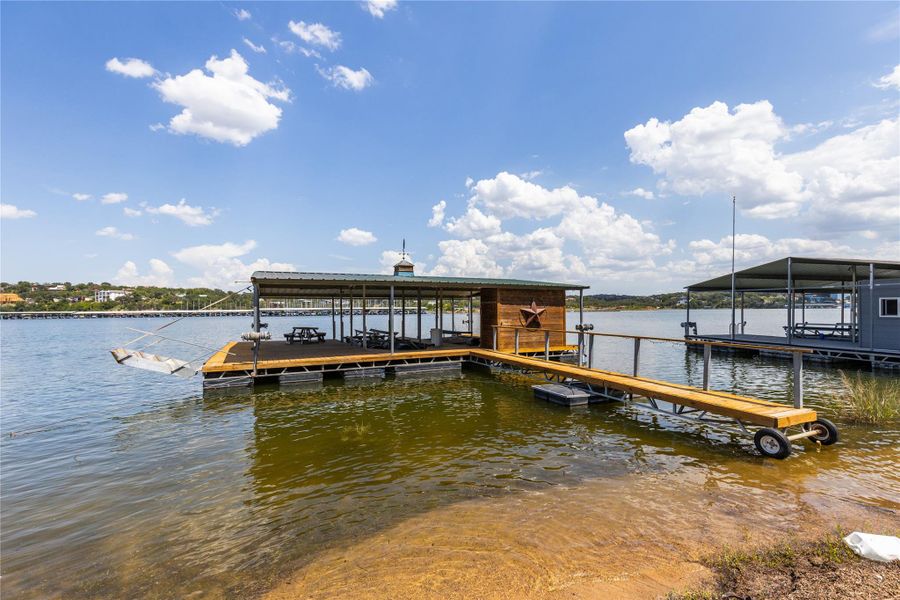 Dock area with boat lift and a water view