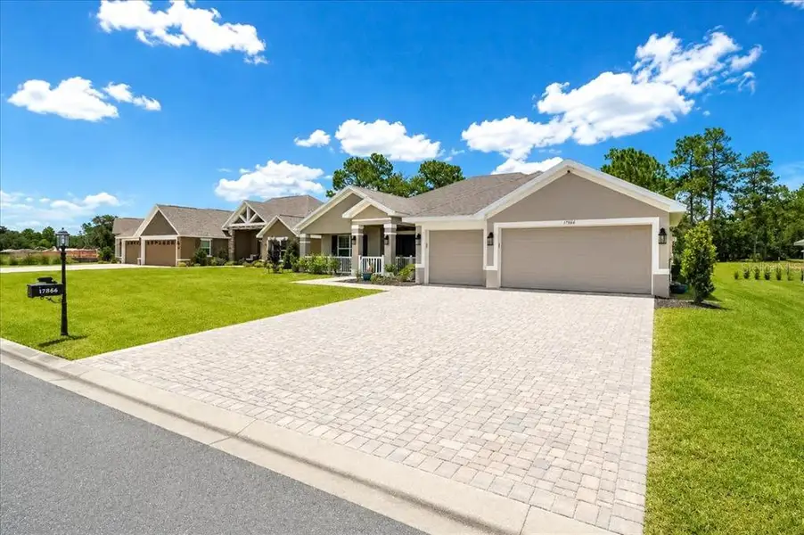 Front exterior of a new home in Juliette Falls, Dunnellon, FL, highlighting curb appeal (Image 26). Front exterior of a new home in Juliette Falls, Dunnellon, FL, highlighting curb appeal (Image 26).