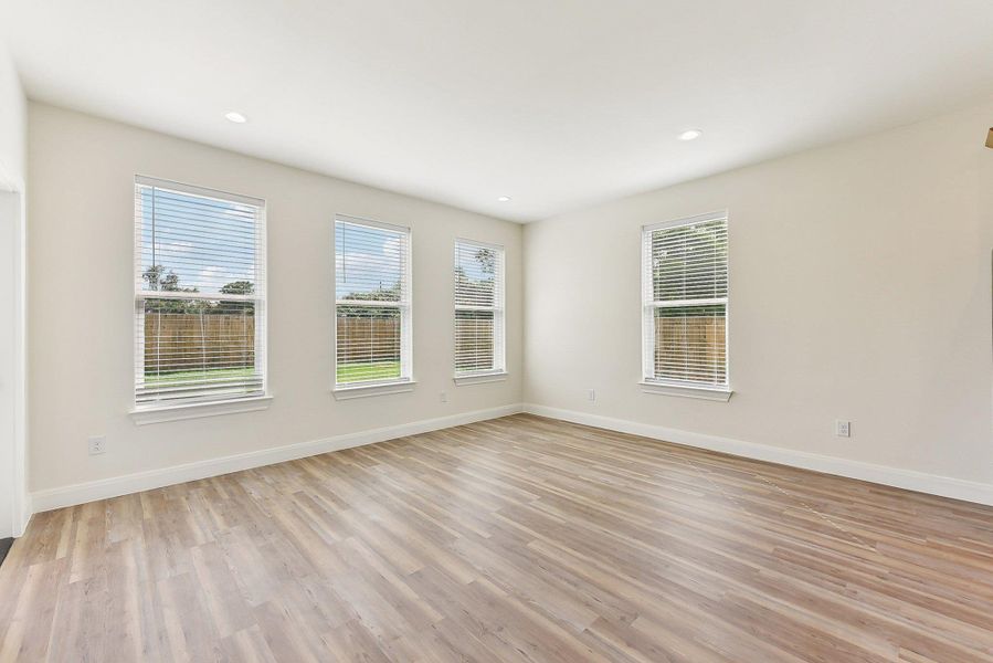 Dining Area with baseboards, a healthy amount of sunlight, light wood look floors, and recessed lighting