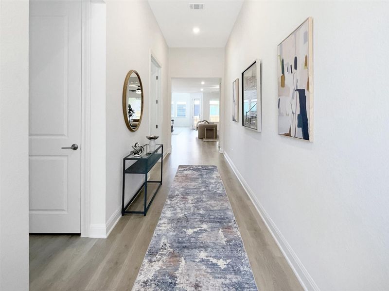 Corridor featuring light wood finished floors and recessed lighting