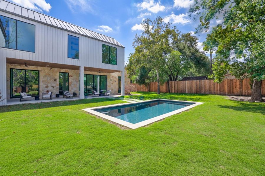 View of pool featuring a patio area, a fenced backyard, and a ceiling fan View of pool featuring a patio area, a fenced backyard, and a ceiling fan