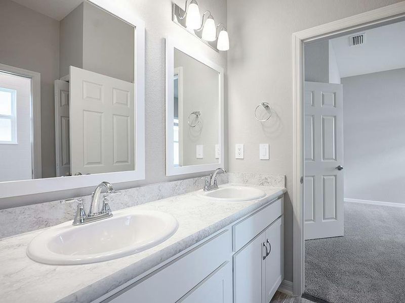 Secondary bedrooms share a Jack-and-Jill bath - Photos showcase a home with similar finishes, not the actual home for sale.