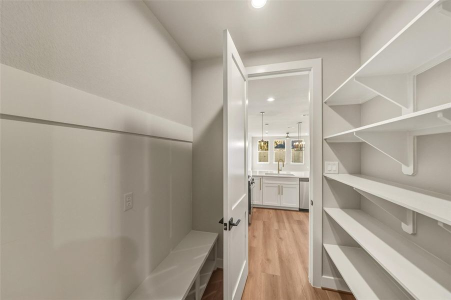 This spacious walk-in pantry offers ample storage for all your essentials, seamlessly blending functionality with style. This spacious walk-in pantry offers ample storage for all your essentials, seamlessly blending functionality with style.