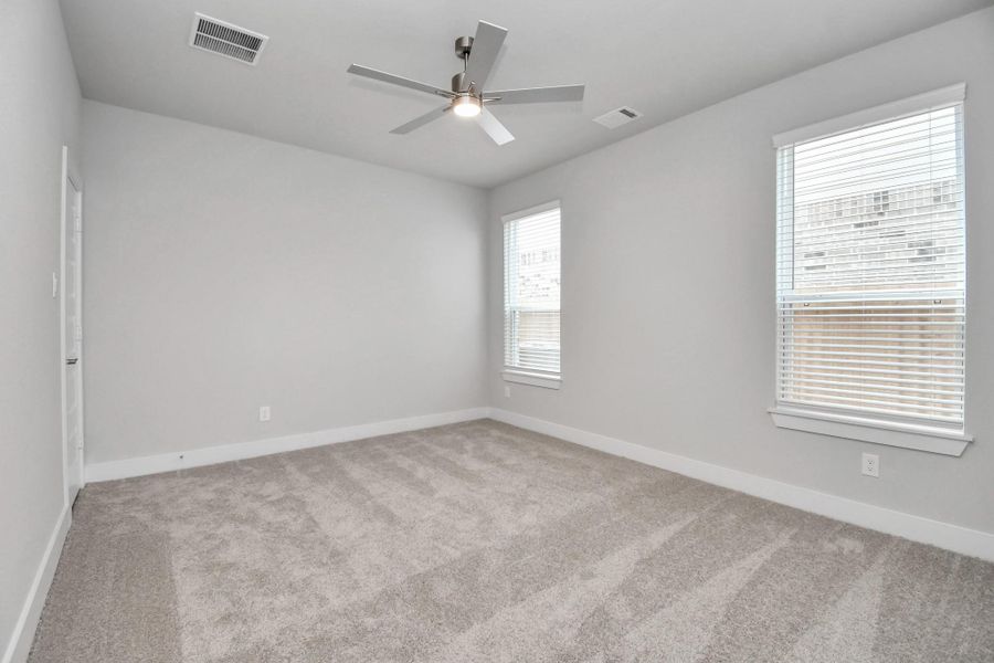 Secondary bedroom features plush carpeting, large windows that let in plenty of natural light, bright paint, and spacious closets. Secondary bedroom features plush carpeting, large windows that let in plenty of natural light, bright paint, and spacious closets.