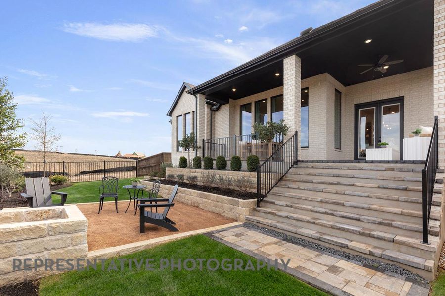Doorway to property with a porch, brick siding, and a ceiling fan Doorway to property with a porch, brick siding, and a ceiling fan
