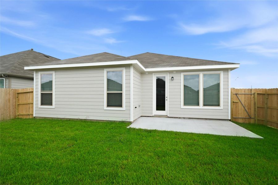 Step outside to the inviting patio slab overlooking the private, fenced backyard with ample green space.