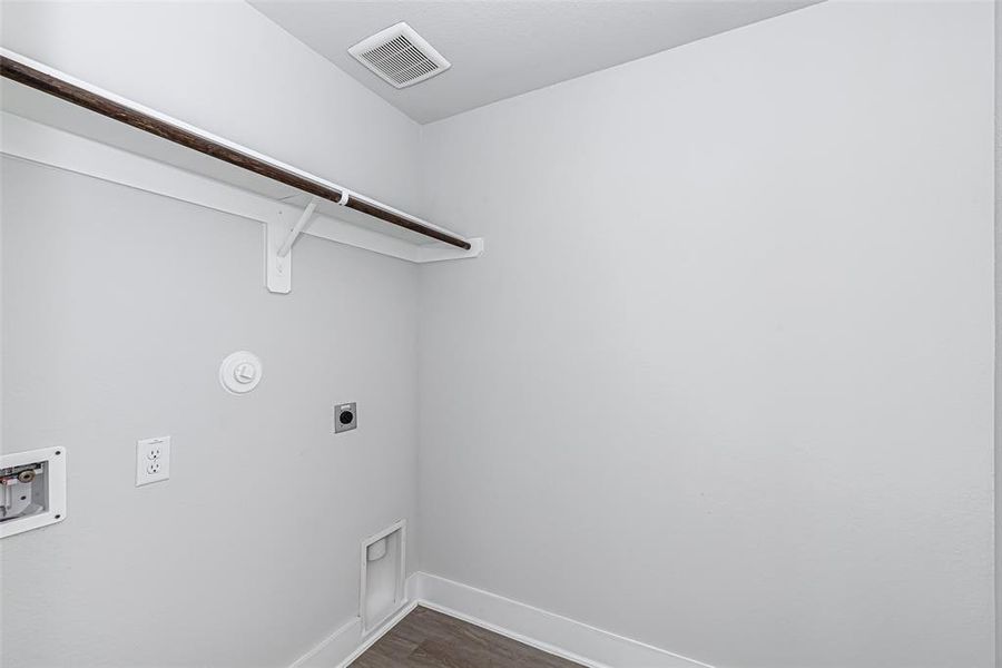 Utility room is large in size with hanging rod for those clothes that need to be air dried!