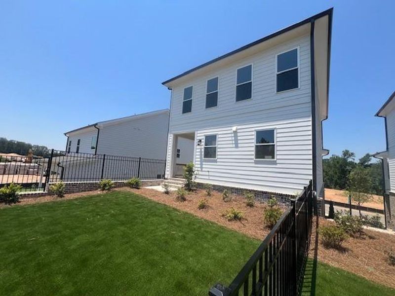 Front exterior of a new home in Palisades Single Family, Cumming, GA, highlighting curb appeal (Image 27).