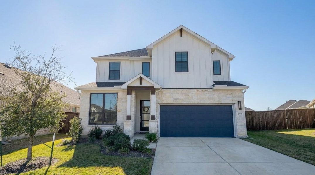 This modern two-story home features a clean, light-colored exterior with stone accents and a dark garage door. It has a well-maintained lawn and simple landscaping. The driveway offers ample parking space, and the property is fenced for privacy. This modern two-story home features a clean, light-colored exterior with stone accents and a dark garage door. It has a well-maintained lawn and simple landscaping. The driveway offers ample parking space, and the property is fenced for privacy.