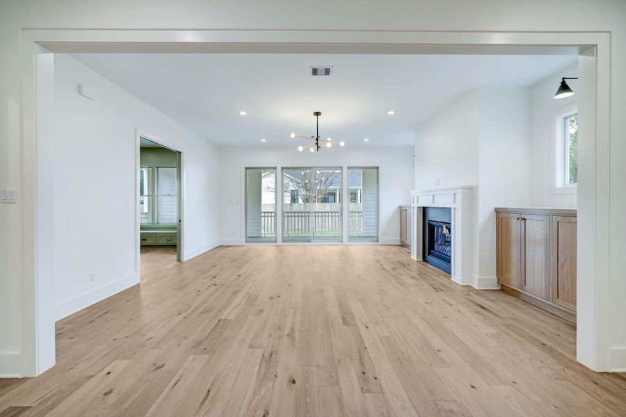 Expansive open concept living designed for both everyday comfort and entertaining, featuring wide plank hardwood floors, custom built ins, a sleek fireplace, and oversized sliding doors that bring in abundant natural light. Clean lines and thoughtful finishes throughout highlight the quality craftsmanship Harvard Homes is known for. *Previous Project*