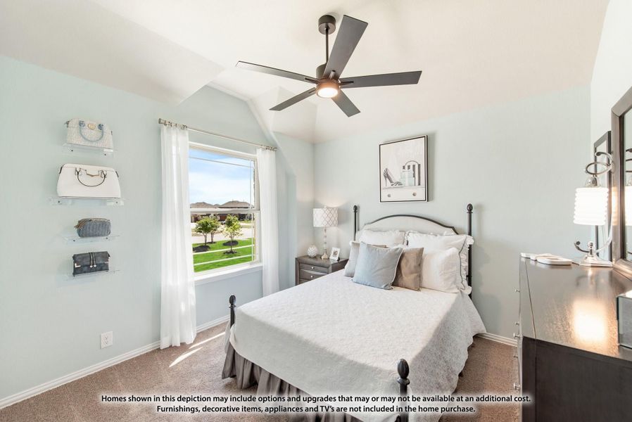 Bedroom with vaulted ceiling, ceiling fan, carpet flooring, and large window with natural light Bedroom with vaulted ceiling, ceiling fan, carpet flooring, and large window with natural light