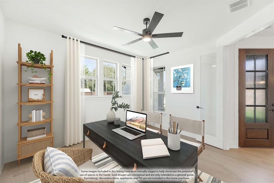 Home office with dark wood desk, ceiling fan, hardwood floors, and ladder shelf near two windows Home office with dark wood desk, ceiling fan, hardwood floors, and ladder shelf near two windows
