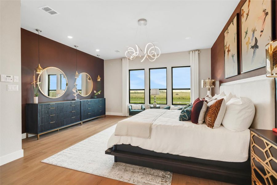 Bedroom featuring multiple windows, a chandelier, wood finished floors, and recessed lighting Bedroom featuring multiple windows, a chandelier, wood finished floors, and recessed lighting