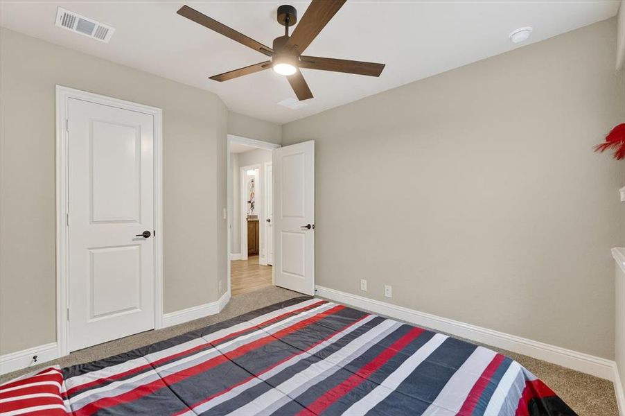 Carpeted room with a ceiling fan, recessed lighting, and light-toned walls Carpeted room with a ceiling fan, recessed lighting, and light-toned walls