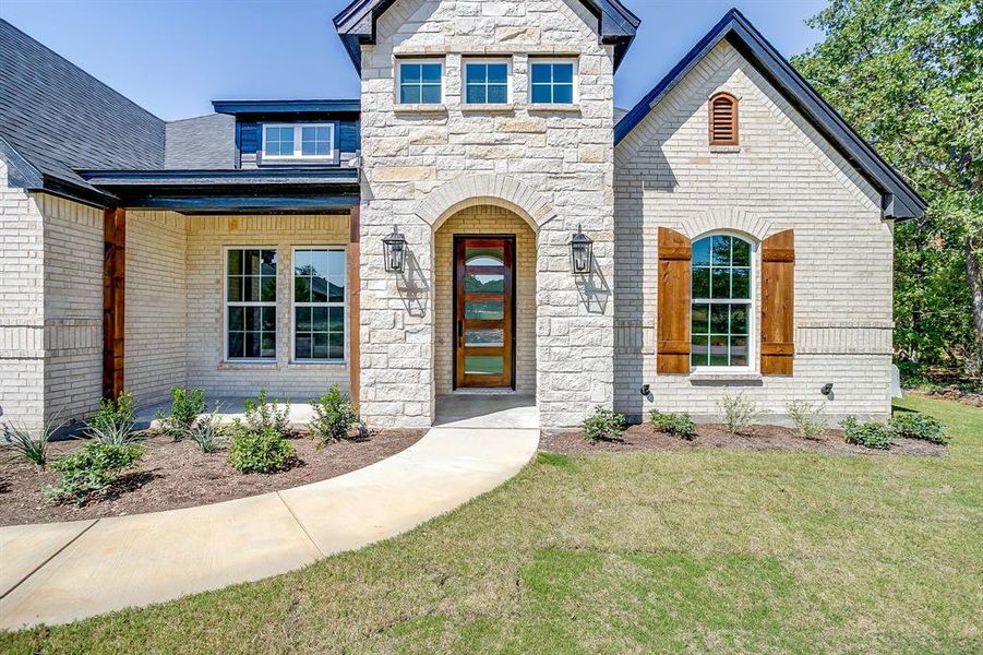 Front exterior of a new home in Escondido Ranches, Poolville, TX, highlighting curb appeal (Image 24). Front exterior of a new home in Escondido Ranches, Poolville, TX, highlighting curb appeal (Image 24).