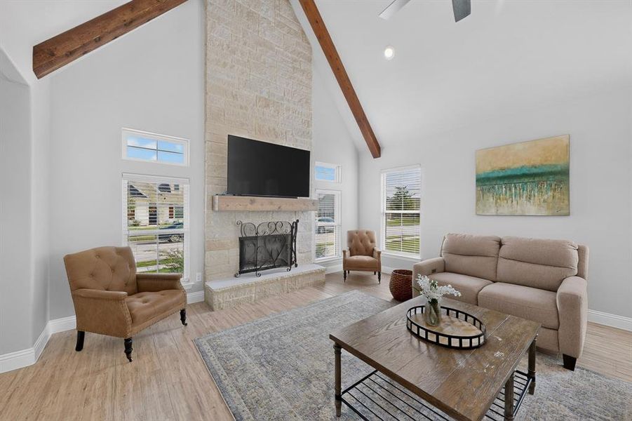 Dramatic floor to ceiling stone fireplace with wood mantle and hearth