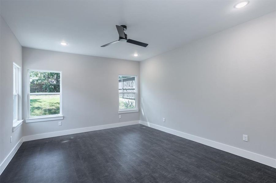 Primary bedroom with dark wood finished floors, a ceiling fan, and recessed lighting Primary bedroom with dark wood finished floors, a ceiling fan, and recessed lighting