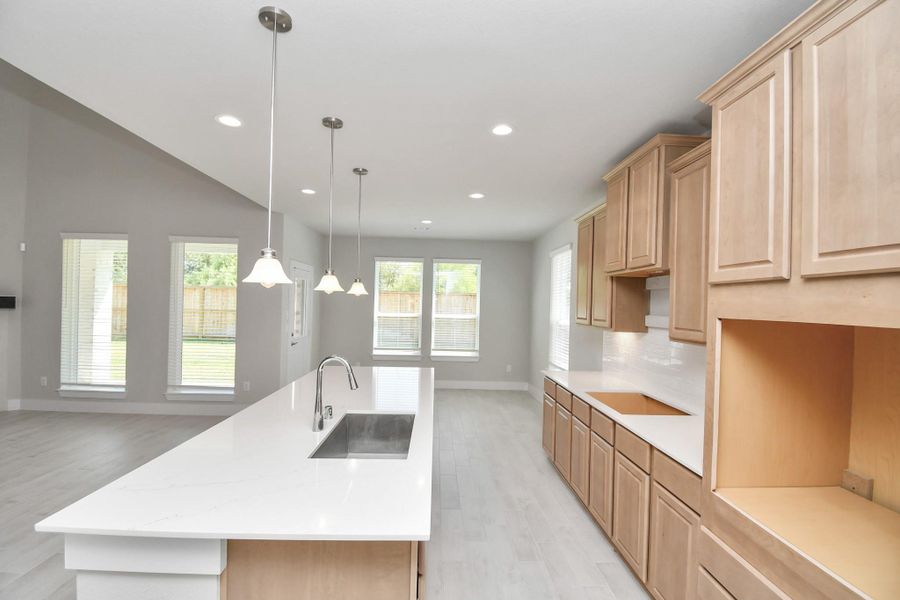 This kitchen is by far any chef’s dream! This spacious kitchen features high ceilings, stained wood cabinets, granite countertop, SS appliances, modern tile backsplash, recessed lighting, extended counter space, granite kitchen island with double sink, and space for breakfast bar, and a walk-in pantry all overlooking your huge family room. Sample photo of completed home with similar floor plan. Actual colors and selections may vary.