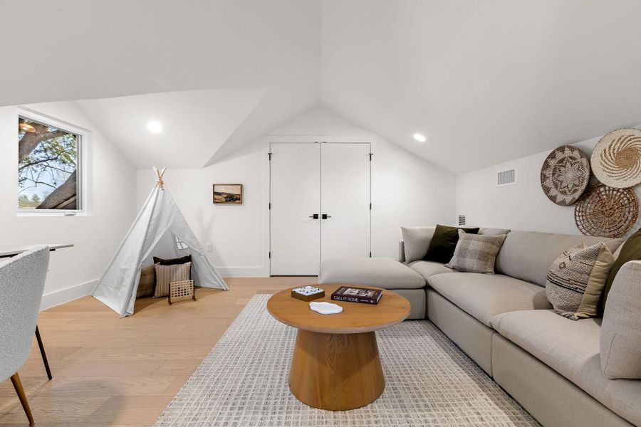 Living room featuring light wood finished floors and recessed lighting