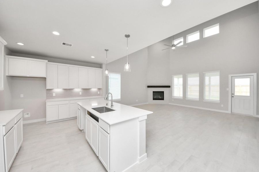 This kitchen is truly a chef's dream! This haven Boasts high ceilings, recessed & pendant lighting, stained wood cabinets, granite countertops, stainless steel appliances, a modern tile backsplash. All of this overlooks your expansive family room, creating a perfect space for culinary delights and family gatherings. Sample photo of completed home with similar floor plan. Actual colors and selections may vary. This kitchen is truly a chef's dream! This haven Boasts high ceilings, recessed & pendant lighting, stained wood cabinets, granite countertops, stainless steel appliances, a modern tile backsplash. All of this overlooks your expansive family room, creating a perfect space for culinary delights and family gatherings. Sample photo of completed home with similar floor plan. Actual colors and selections may vary.