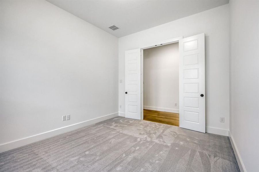 Unfurnished bedroom featuring carpet floors and baseboards