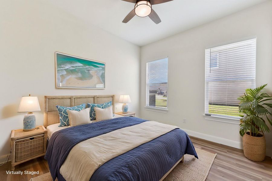 Virtually Staged Bedroom 3 featuring ceiling fan, baseboards, multiple windows, and wood finished floors Virtually Staged Bedroom 3 featuring ceiling fan, baseboards, multiple windows, and wood finished floors