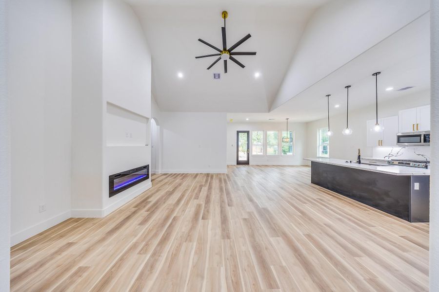 Enjoy an open-concept design where the living area, kitchen, and dining flow seamlessly beneath soaring ceilings. Enjoy an open-concept design where the living area, kitchen, and dining flow seamlessly beneath soaring ceilings.