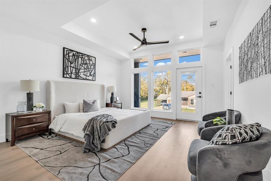 Bedroom featuring hardwood / wood-style flooring, ceiling fan, and access to outside