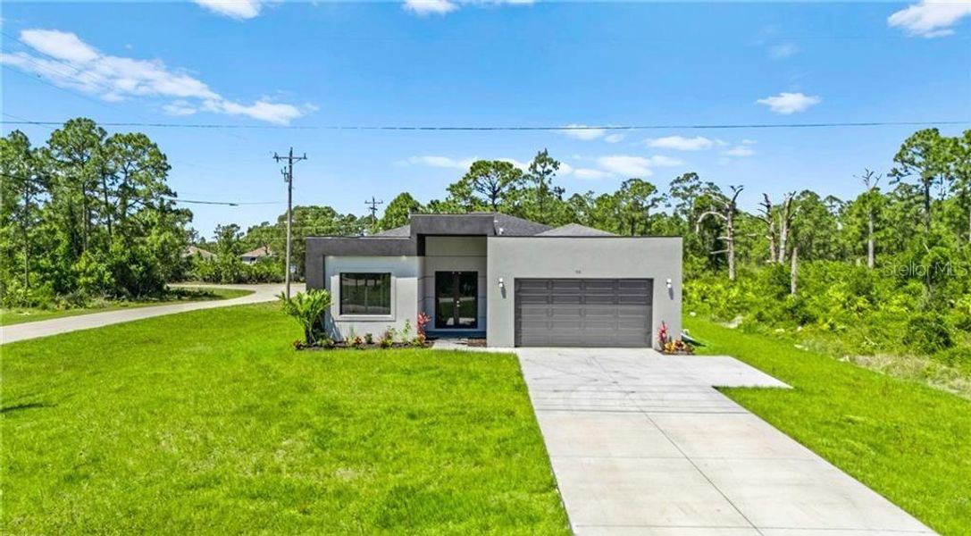 Front exterior of a new home in , Lehigh Acres, FL, highlighting curb appeal (Image 28).