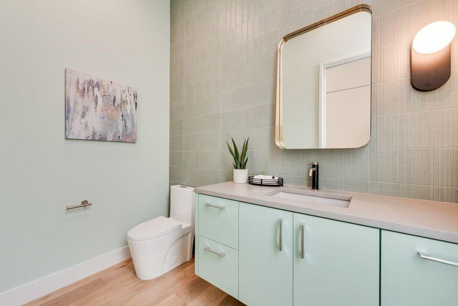 The powder bath is finished with elevated materials and a modern aesthetic.