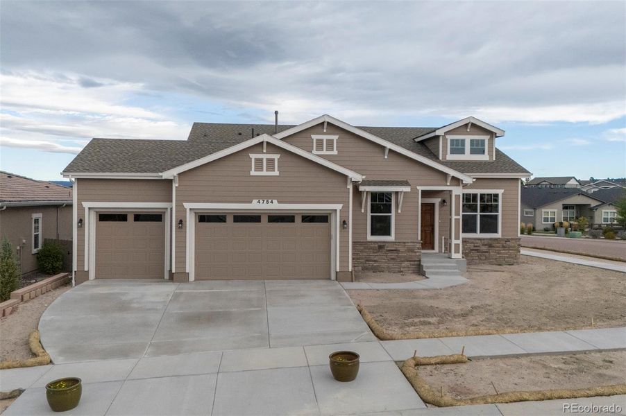 Front exterior of a new home in , Colorado Springs, CO, highlighting curb appeal (Image 1).