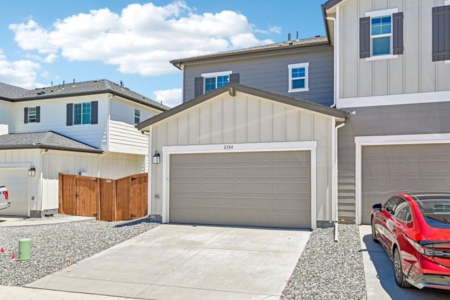 Front exterior of a new home in Farmlore Villas, Brighton, CO, highlighting curb appeal (Image 17).