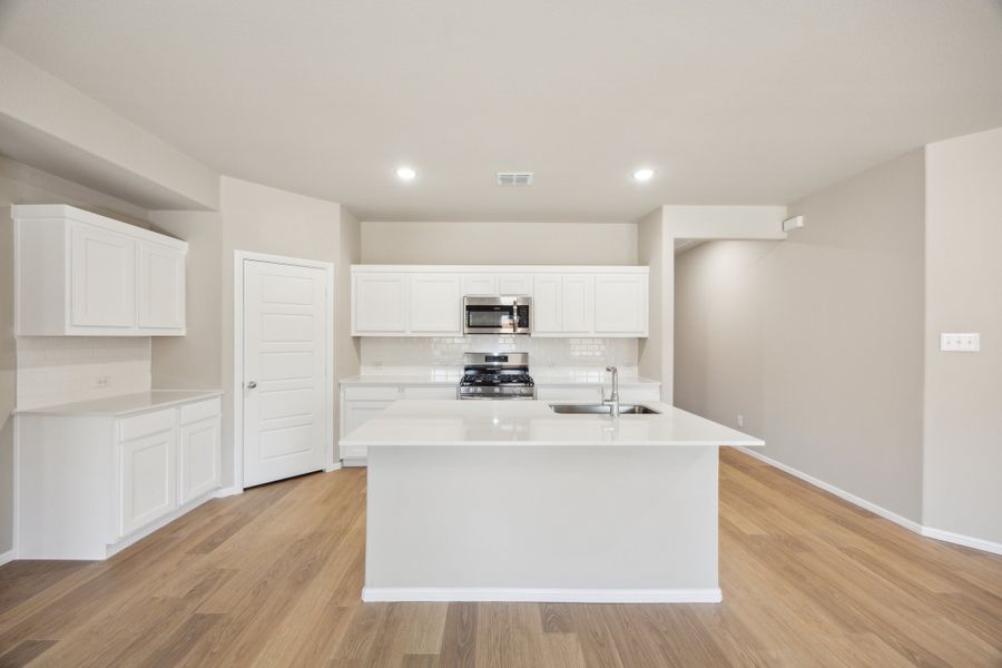 Kitchen in the Harper home plan by Trophy Signature Homes – REPRESENTATIVE PHOTO