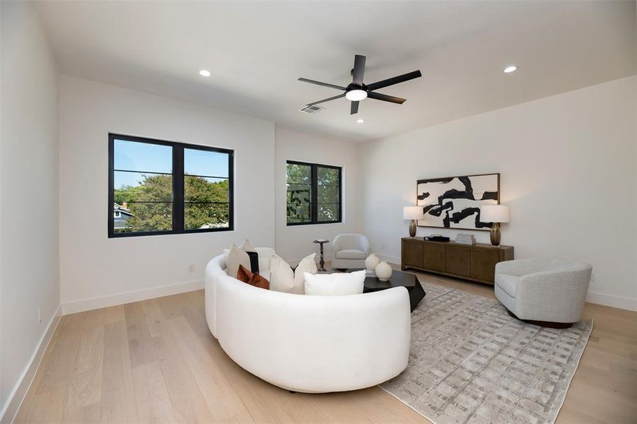 Living area featuring light wood finished floors, recessed lighting, and ceiling fan Living area featuring light wood finished floors, recessed lighting, and ceiling fan