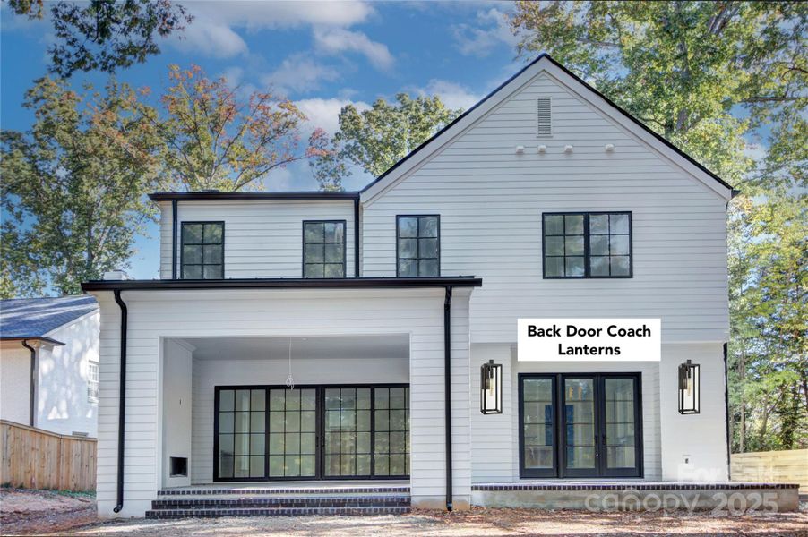 Rear of house, covered porch has a gas fireplace. Lanterns depicted to be installed Rear of house, covered porch has a gas fireplace. Lanterns depicted to be installed