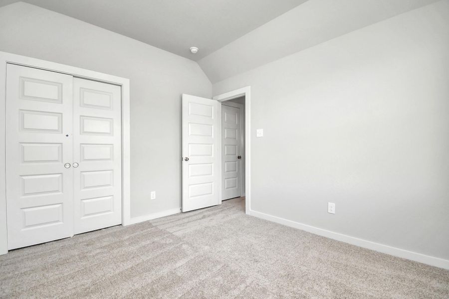 Generously sized secondary bedrooms, complete with spacious closets and soft, inviting carpeting. Sample photo of completed home with similar floor plan. Actual colors and selections may vary.