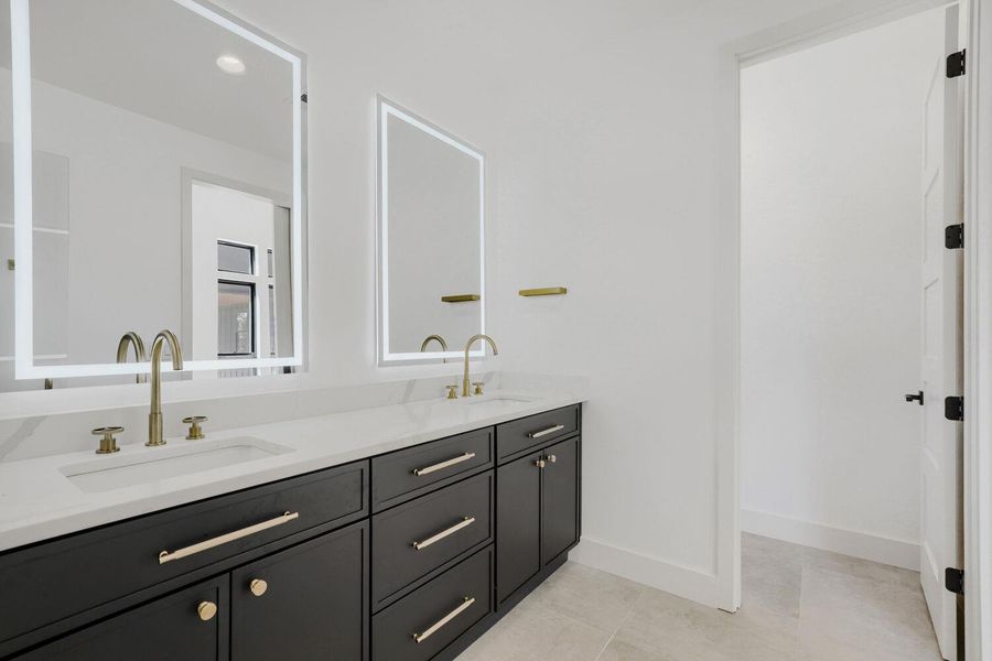 Bathroom featuring double vanity, light tile patterned floors, and recessed lighting Bathroom featuring double vanity, light tile patterned floors, and recessed lighting