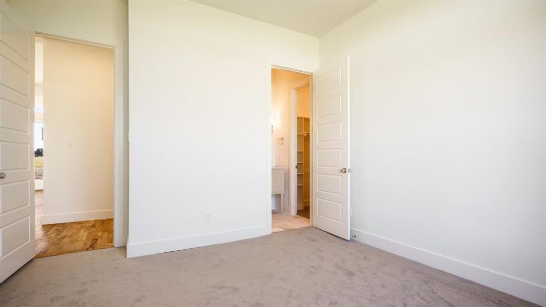 Unfurnished bedroom featuring light carpet