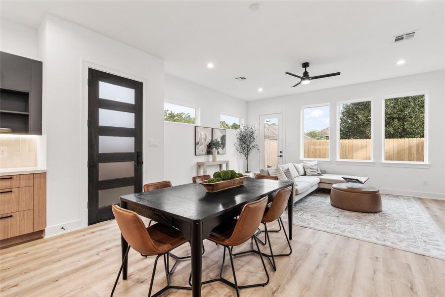 From the moment you stepinside, natural light poursthrough wide picture windows,revealing an open-concept livingspace that feels both grand andgrounded.