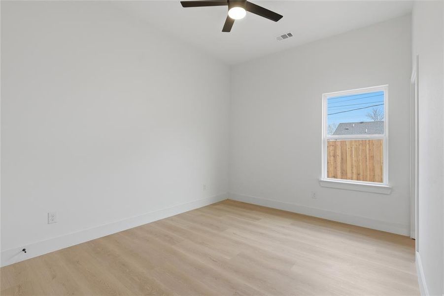 Spare room featuring light wood-style flooring and a ceiling fan Spare room featuring light wood-style flooring and a ceiling fan
