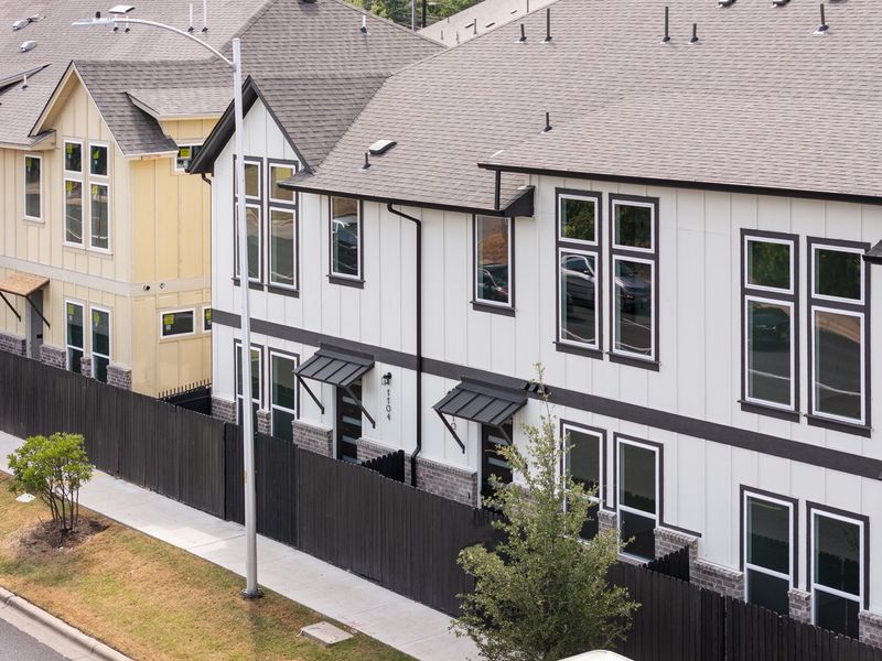 Front exterior of a new home in Koenig Townhomes, Austin, TX, highlighting curb appeal (Image 1).