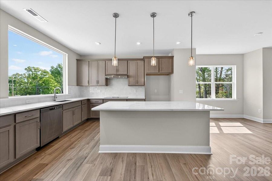Gourmet kitchen with large windows for ample natural light