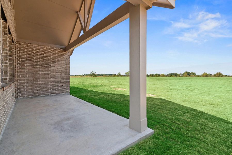 Covered patio with views of the huge backyard Covered patio with views of the huge backyard